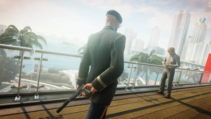 Agent 47 holding a silenced pistol behind his back in Hitman 2