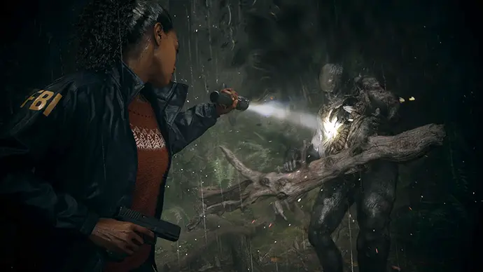 Alan Wake 2 survival horror screenshot – FBI agent with flashlight confronting monster