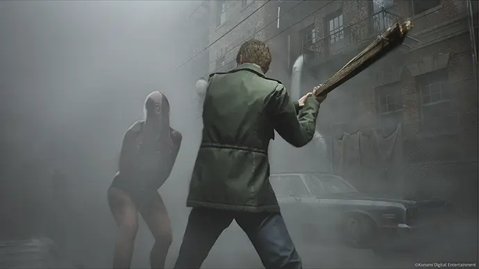 Silent Hill 2 Remake survival horror screenshot – protagonist fighting monster in foggy street